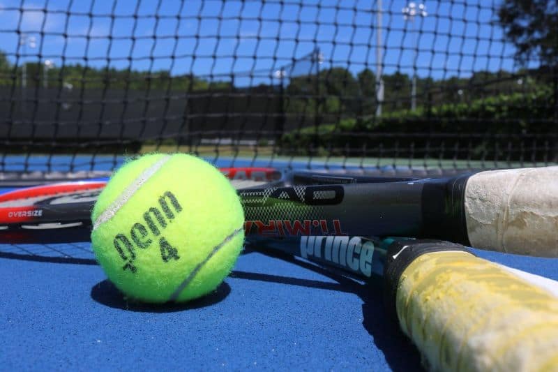 Tennis ball and rackets on court