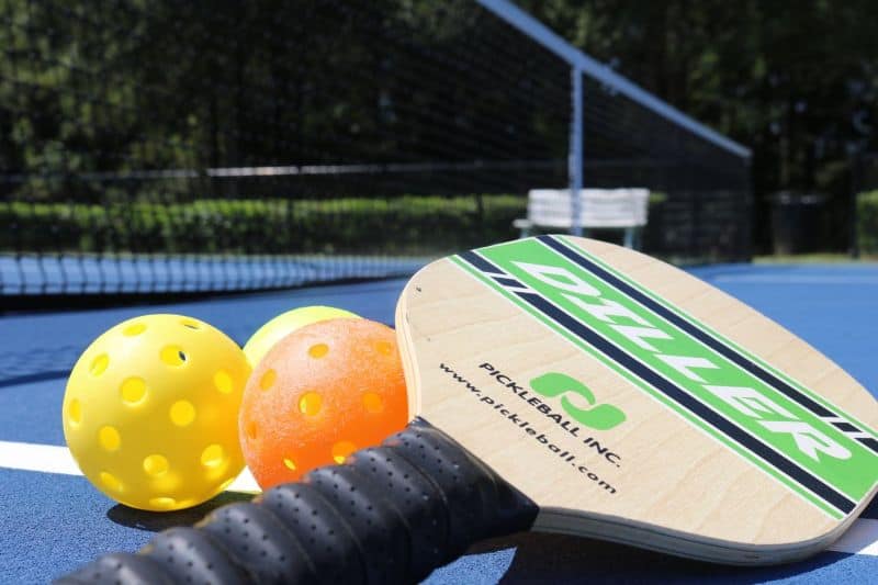Pickleballs and racket on court