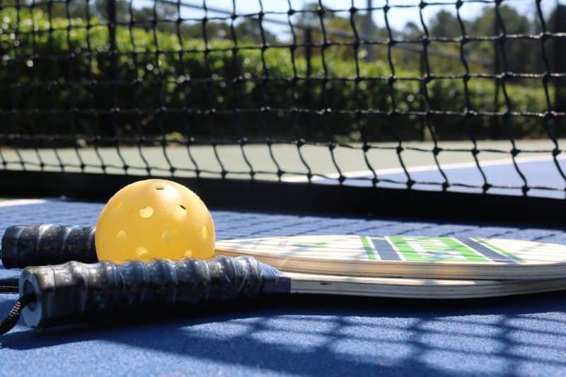 Pickleball and racket on court